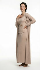 Woman wearing a beige outfit with a long cardigan on a white background